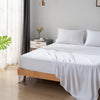 Bed with white bamboo bedding in a bedroom setting