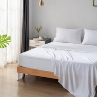 Bed with white bamboo bedding in a bedroom setting